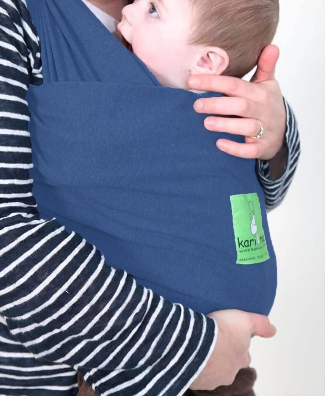 Person holding a baby in a blue sling with a visible brand logo on a white background